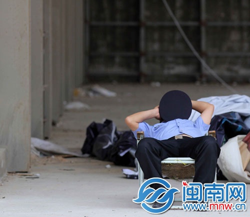 一名保安躺在一旁休息