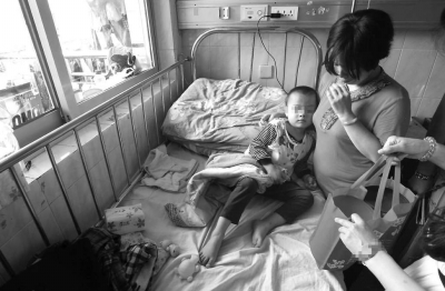 小智依偎在母亲怀中。