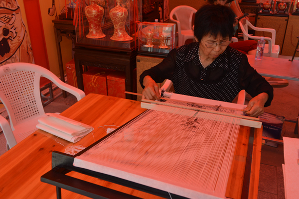 本土艺人展示纸织画制作过程