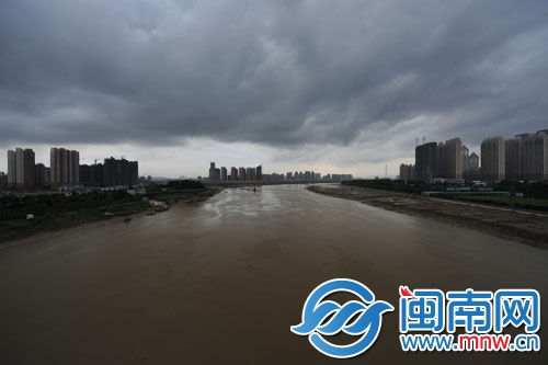 乌云笼罩在晋江两岸的城市上空，雨水随即降下