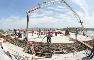 昨日，工人正在晋安大桥合龙段上抓紧浇灌混凝土。本