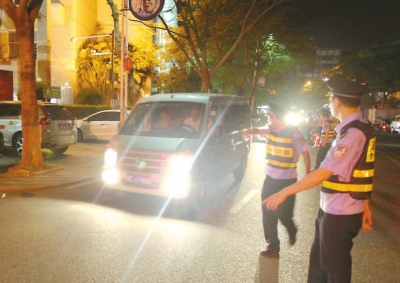 交警拦下滥开远光灯车辆。本报记者朱晨辉摄