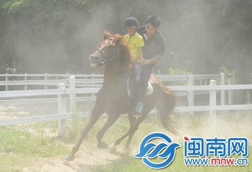小记者在教练的保护下，神采飞扬地骑马
